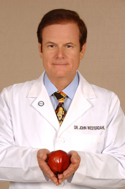 Dr. John Westerdahl holding an apple
