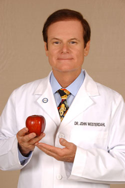 Dr. John Westerdahl presenting an apple
